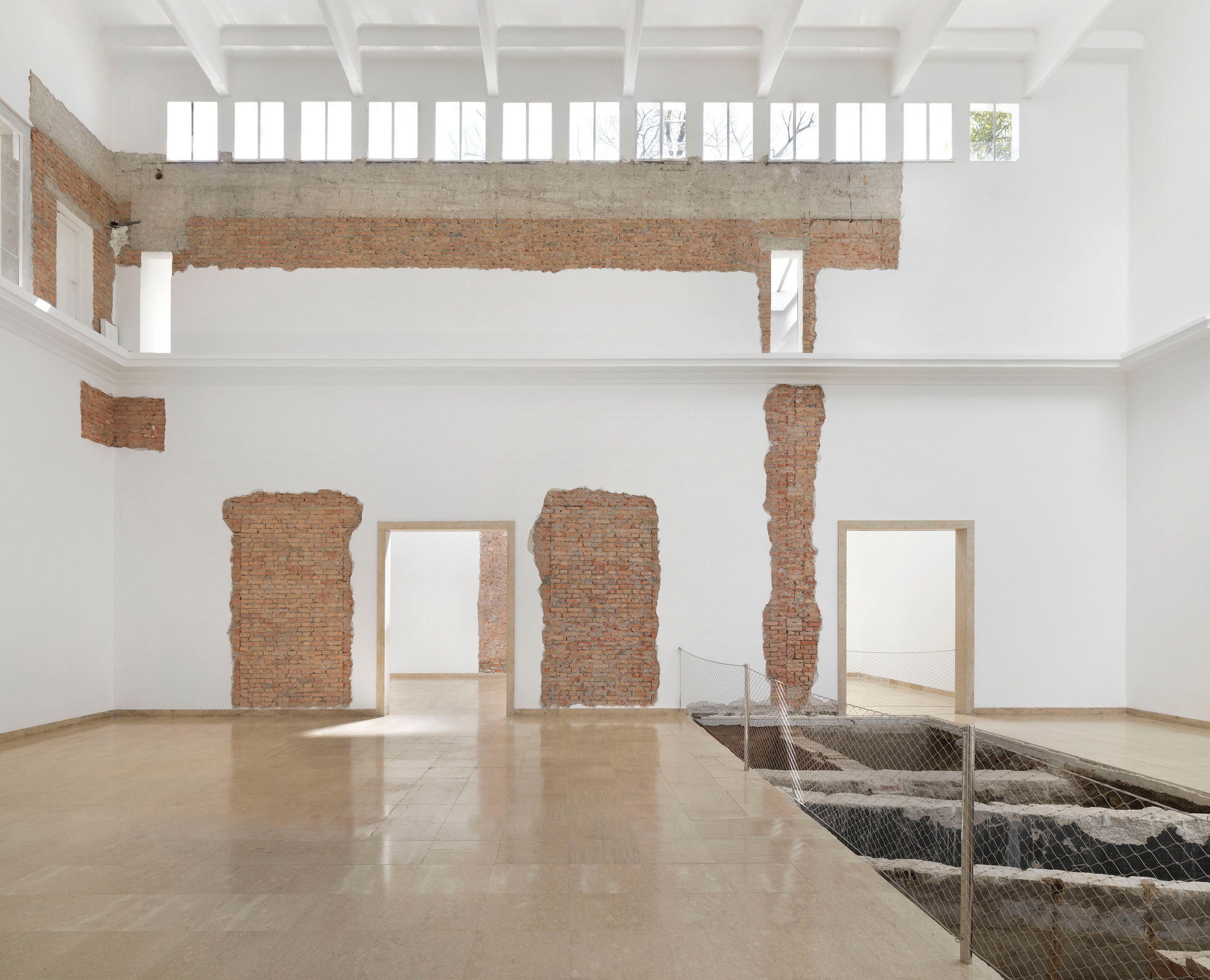 Maria Eichhorn, Relocating a Structure. German Pavilion 2022, 59th International Art Exhibition – La Biennale di Venezia, 2022, detail: Join between sections of the building from 1909 and 1938; wall lettering; doorwayto the left front side room from 1909, walled up in 1938; doorway to the left rear side room from 1909, walledup in 1928; foundations of the rear wall from 1909; rear wall of the building from 1909, interior wall from 1938, demolished in 1964, exhibition view, © Maria Eichhorn / VG Bild-Kunst, Bonn 2022, photo: Jens Ziehe